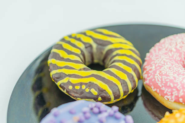 istock Six colorful doughnuts with various toppings and glazes are displayed on a dark surface 2197088131