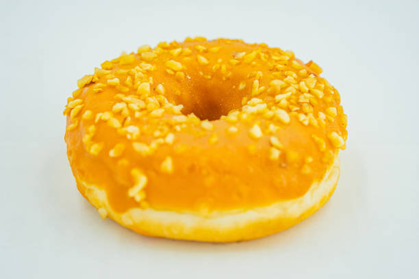 istock A golden-brown doughnut with seed-like toppings against a light background 2197088255