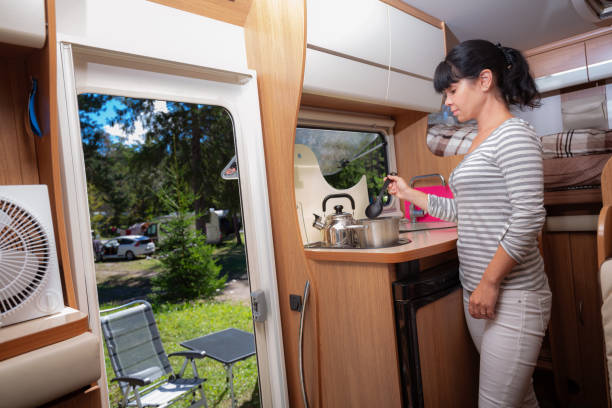 istock Woman cooking in camper, motorhome interior RV 2197091597