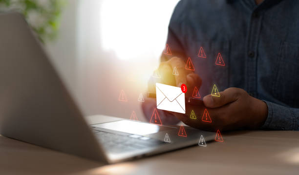 istock A Businessman working on a laptop open an email with triangle caution warning sign for notification error and maintenance concept, network security, computer virus detected, personal data protection. 2197096445