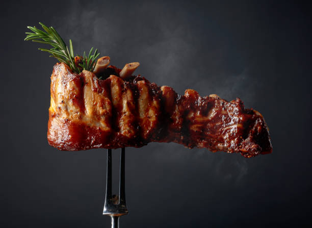 istock Grilled pork ribs with rosemary on a fork. 2197098672