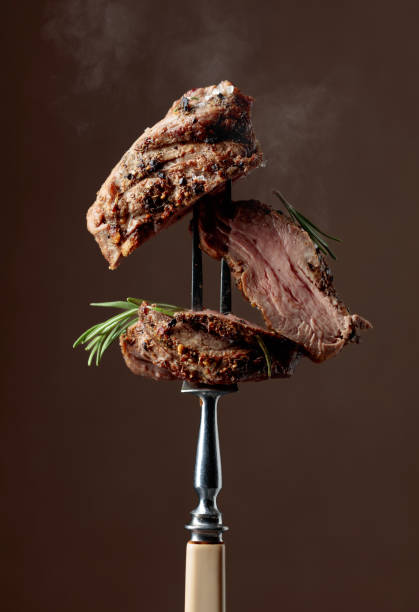 istock Grilled ribeye beef steak with rosemary on a brown background. 2197098676