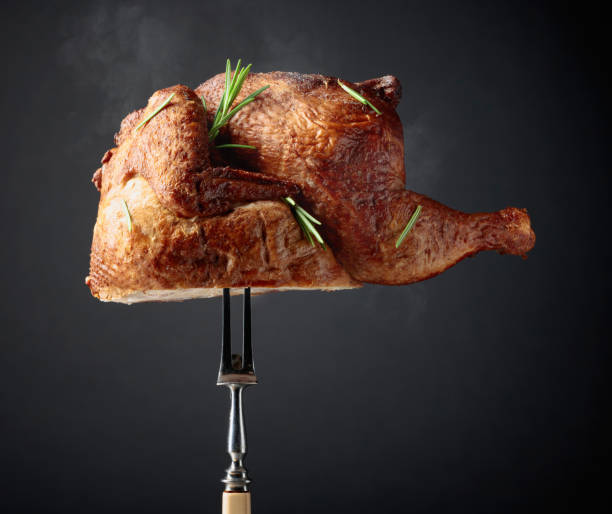 istock Smoked chicken on a fork sprinkled with rosemary. 2197098689