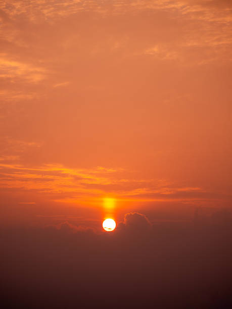Clouds pass in front of the sun at a beautiful sunrise