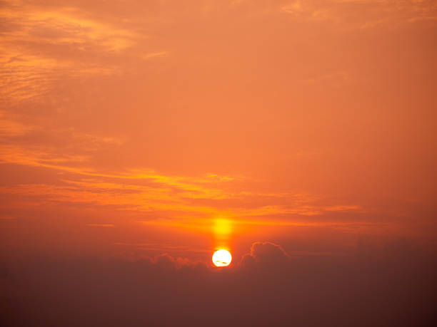 Clouds pass in front of the sun at a beautiful sunrise
