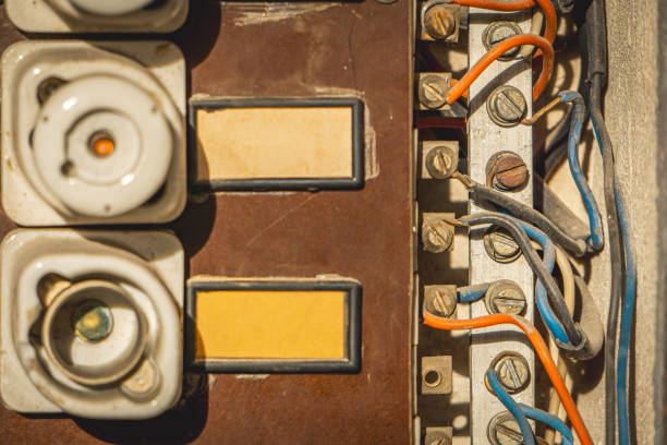 old fuse box. old electrical installation in an electrical cabinet. small and large fuses. electric cables.