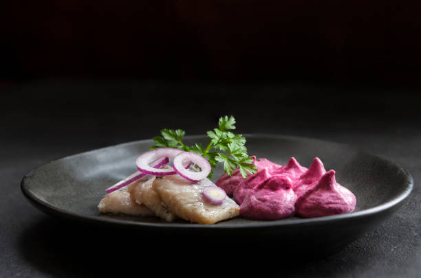 istock Homemade savory Beetroot mousse with lightly salted, pickled herring slices and red onion rings 2197101416
