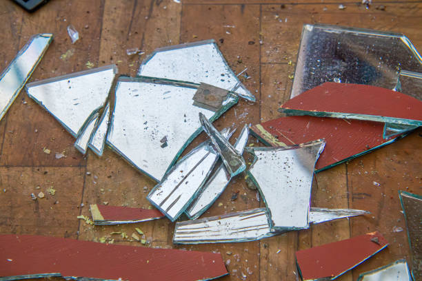 istock a broken mirror lying on a dirty floor in an old abandoned production plant. pipe connections. 2197101480
