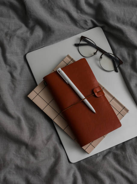 istock Laptop, notebook, glasses on a gray textile background, top view 2197103652