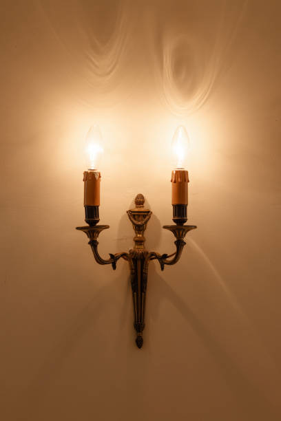 istock A wall mounted light fixture with two candles 2197107106