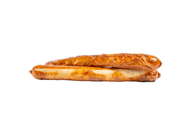 Two grilled sausages lie on a white background. Fried sausage isolated on white