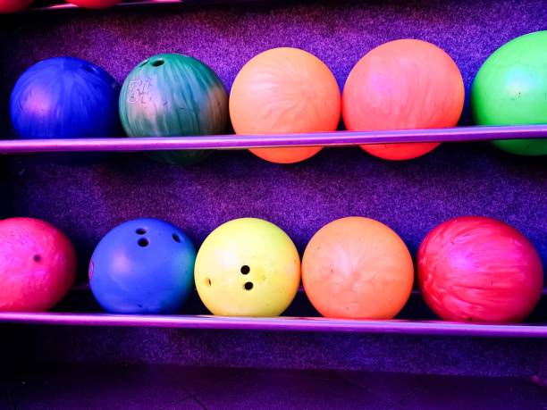 istock Colorful bowling balls resting on a metal rack, ready for a game 2197111454