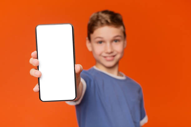 istock Cute boy man showing blank cellphone screen 2197112085