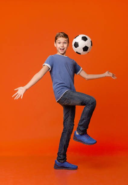 Soccer player practicing dribbling with friends in a team. Group of school teenagers kicking soccer balls during a training session. Boys in football club in cleats improving ball possession skills