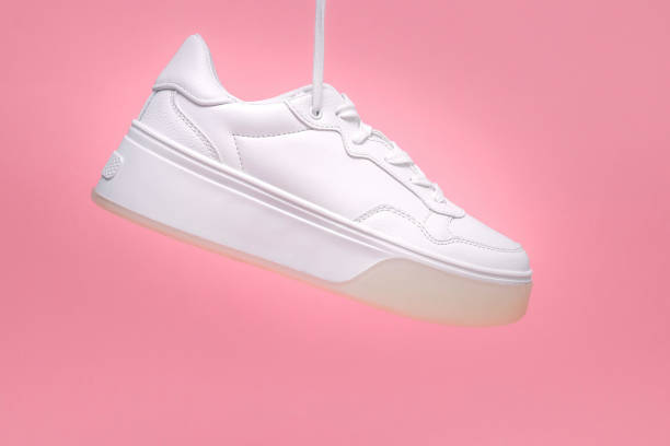 istock White sneakers on a pink background. 2197114900