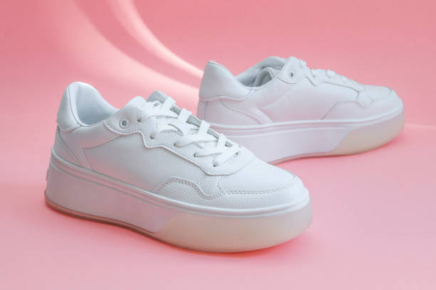istock White sneakers on a pink background. 2197115695