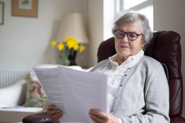 istock Senior woman reading documents indoors 2197117193