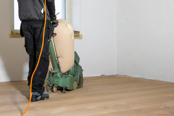 istock Worker Polishing Light Wooden Floor in Renovation Setting 2197118468