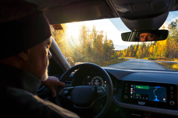 istock Perspective of a man driving a car at sunset 2197120199