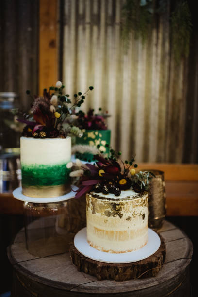 istock Miniature wedding cakes with gold leaf decoration on icing and flowers and berries 2197121180