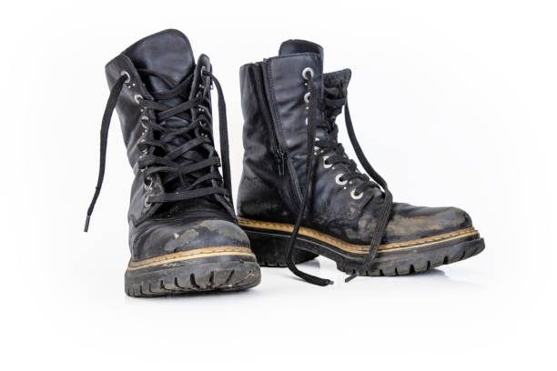 istock Pair of rugged worn black ankle leather combat boots with  thick, sturdy soles and laces. Two vintage military style shoes. Studio light. Isolated on white background. Empty copy space. Clipping path 2197121372