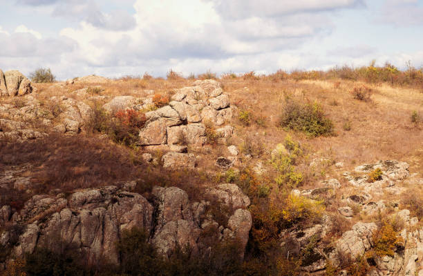 fantastic autumn in a mountain canyon, huge rocks. Mountains of large granite boulders, stone ledges for mountaineering and walking. trees grow among the rocks. Aktovsky Canyon, Ukraine.