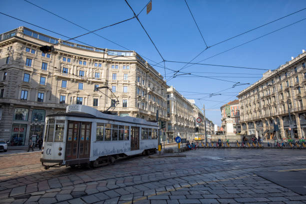 Downtown street view, Milan, Italy in the morning. A white tram passing by.