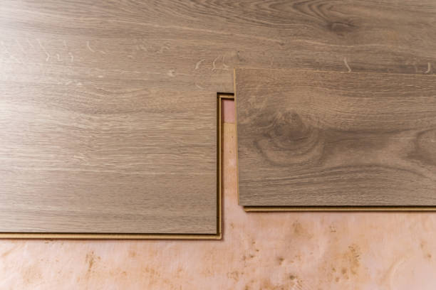 istock Laminate flooring installation showing assembly of interlocking wood planks on underlayment for home renovation project 2197128691