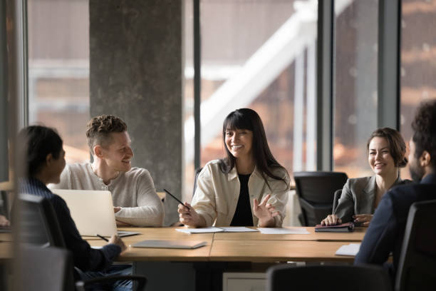 istock Cheerful Latin female team leader holding group meeting 2197130128