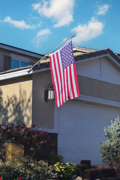 istock US flag mounted on the eave of a home 2197132842