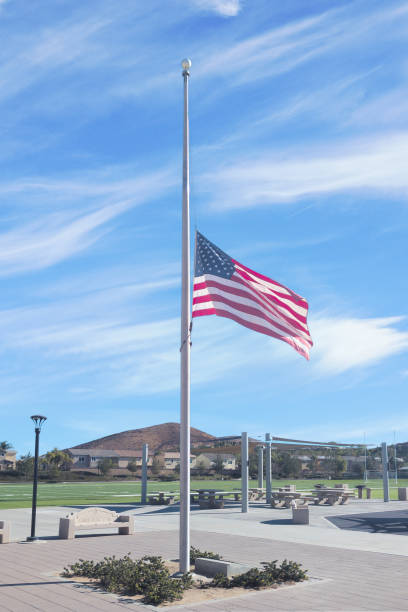 istock US Flag flying at half staff in memoriam in public park 2197132911