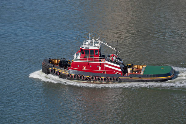 Charleston, SC, USA - February 01, 2025: Moira McAllister, a 30-meter twin-screw 5000-horsepower tugboat owned by McAllister Towing and Transportation, cruises out of Charleston Harbor.