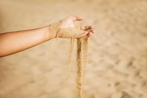 istock The sand slowly drips like time from our hands 2197139734
