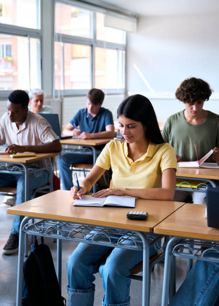 istock A diverse group of multiracial students aged 18 to 20 in a classroom, attentively taking notes 2197139851