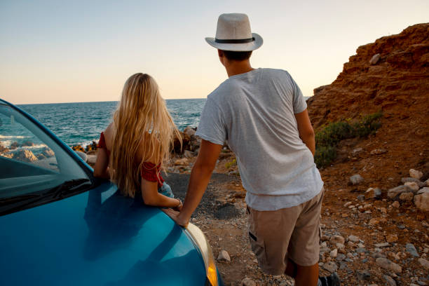 istock Young couple on a road trip at the coastline 2197141771