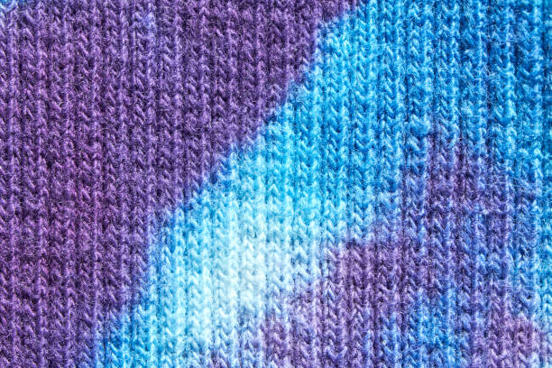 istock Close up of blue and purple tie dye knitted fabric texture pattern background 2197142332