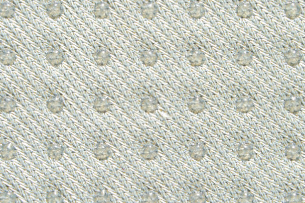 Textured knitted fabric with raised pattern in subtle beige tones for fashion and interior design applications.