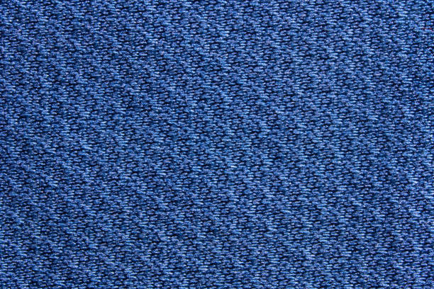 Close up of textured blue fabric with detailed weave pattern for background or design inspiration.