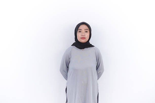 istock Indonesian Asian woman wearing hijab standing with hands behind her back 2197145292