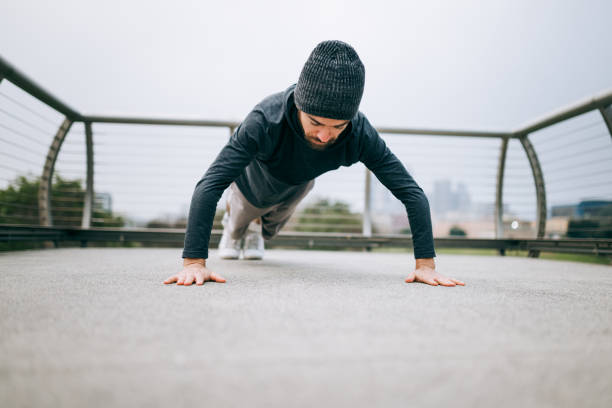istock Latin Athlete Doing Pushups in City Park 2197146148