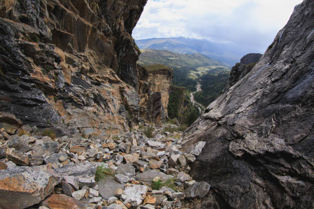 Steep cliff rocks leading to a high mountain top landscape