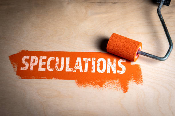 istock Speculations. Orange paint and paint roller on wooden background 2197152429