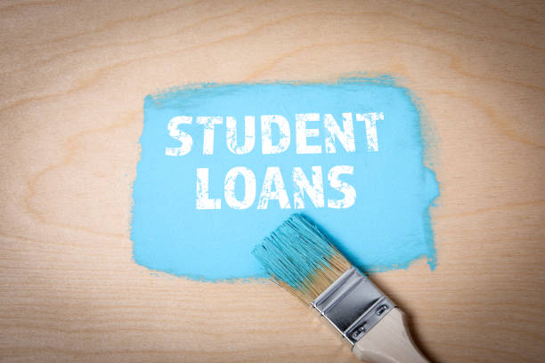 istock Student Loans. Blue paint and paintbrush on wooden background 2197152434