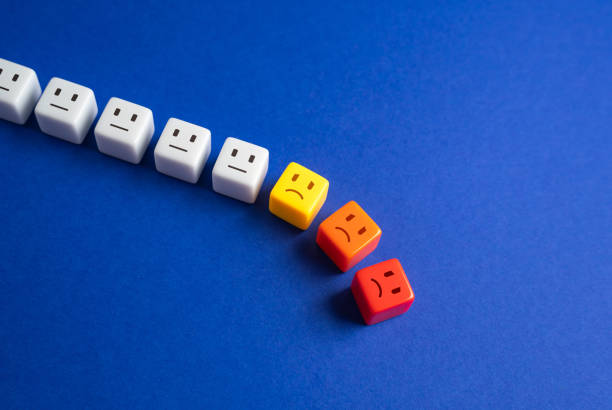 istock Blocks with faces crumbles, the unfortunate ones leave the line. Falling popularity, decreasing viewers or customers. Participants and employees leaving. Bad mood, difficulties and toxic environment. 2197156616