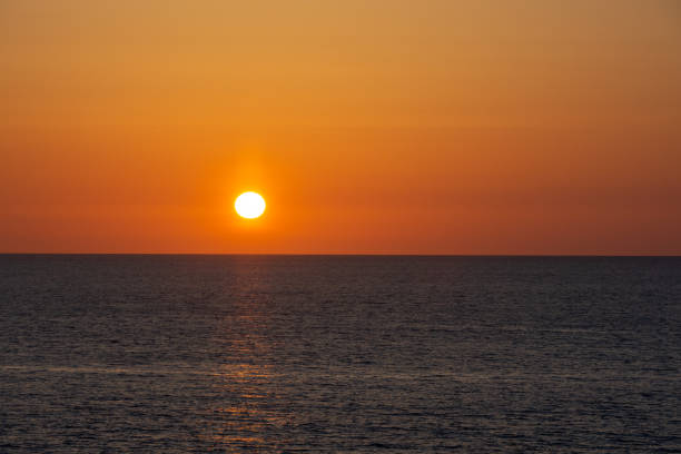 istock Sunset over the quiet sea 2197157540