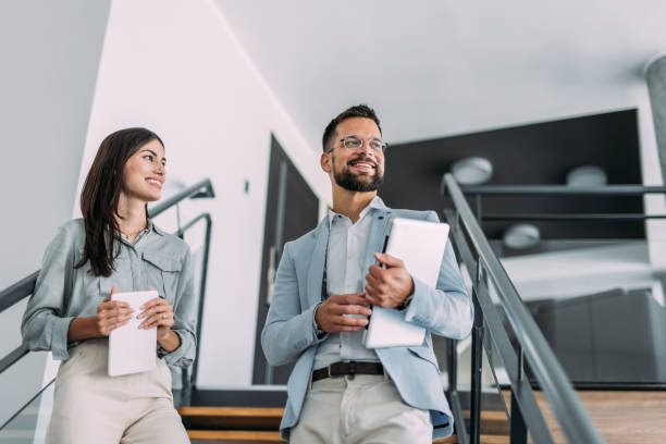 istock Business colleagues talking on stairs in the office. 2197157626