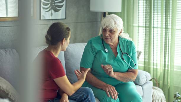 istock Experienced Female GP Doing Home Visit. Home Healthcare. 2197157788