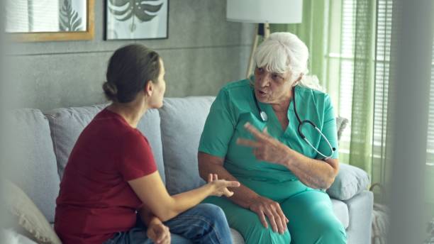 istock Experienced Female GP Doing Home Visit. Home Healthcare. 2197157789