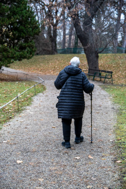 istock Senior citizen walks down a Vienna street with her walking stick 2197158791