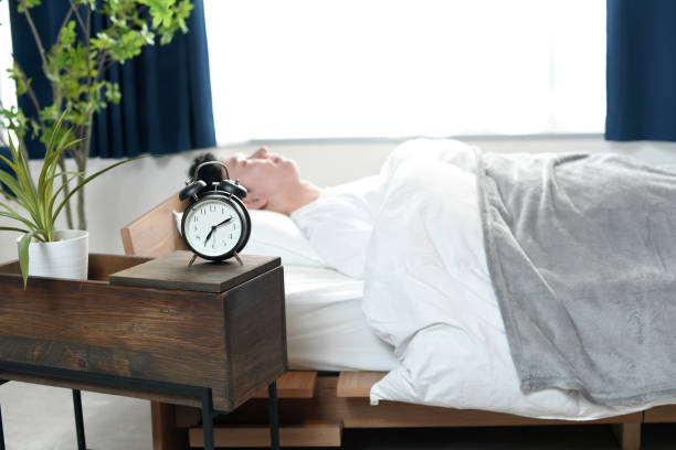 istock Asian young man sleeping comfortably on bed 2197165426